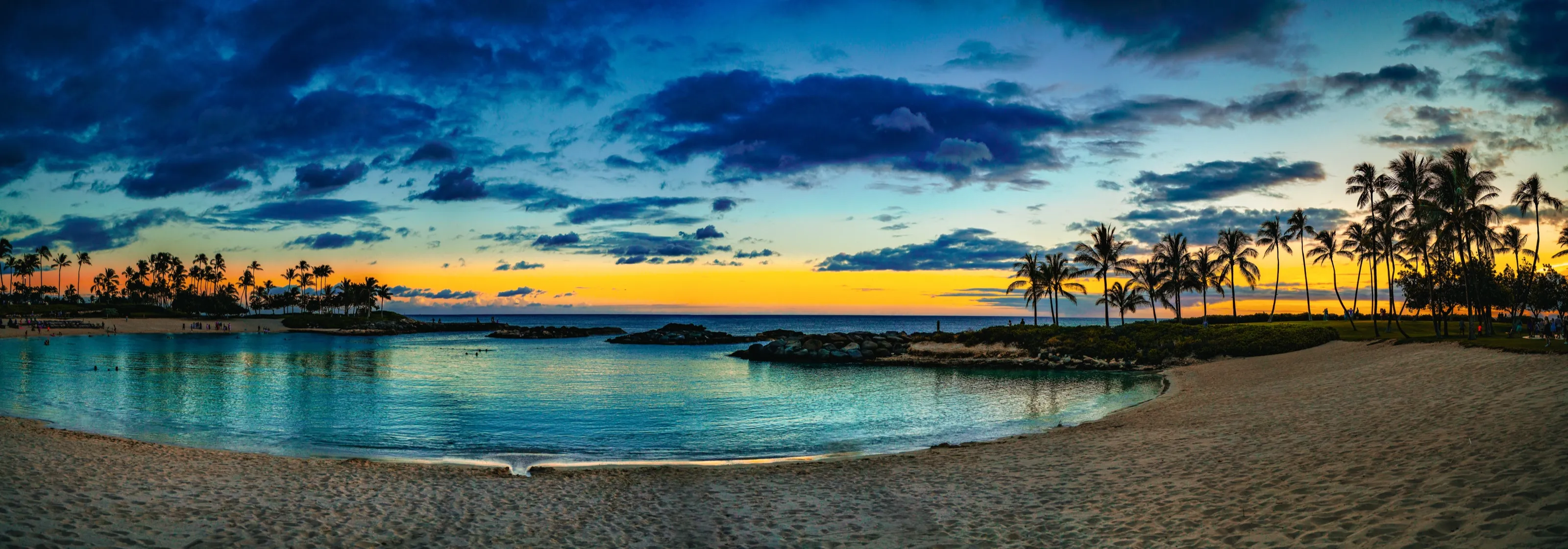 Sunset over a calm sheltered lagoon and palms at Ko Olina on Oahu