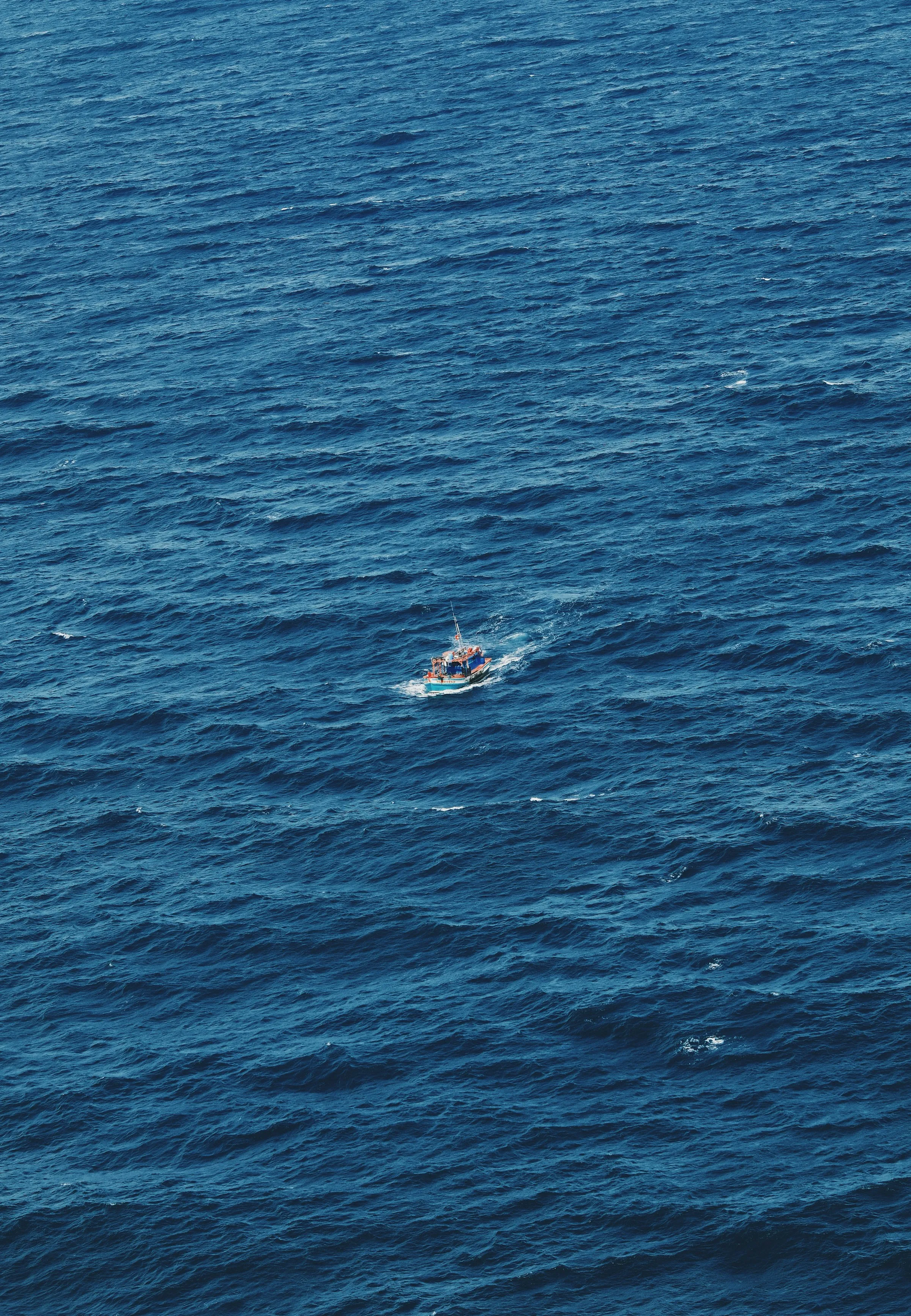 A sportfishing boat far out on deep blue ocean