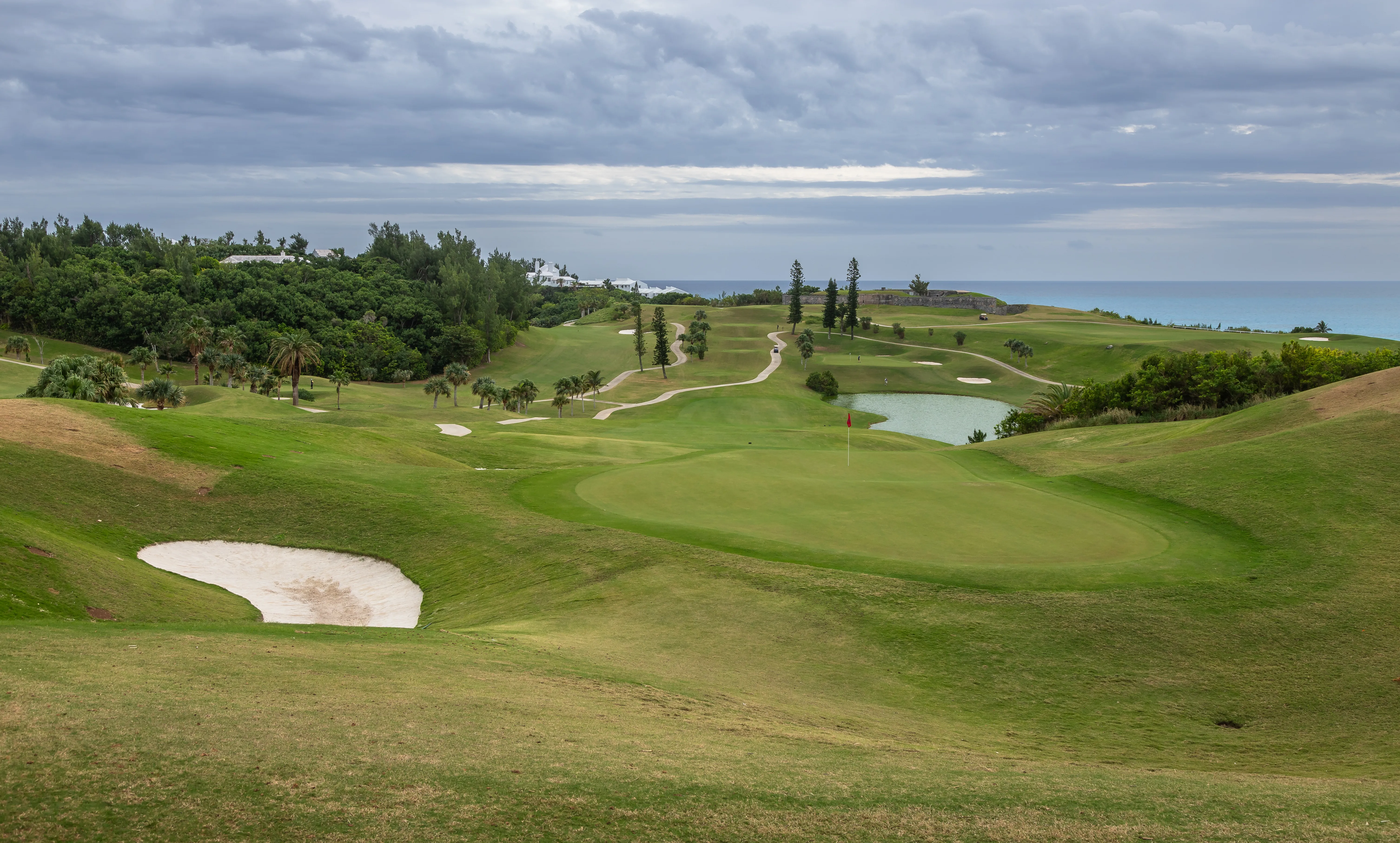 A clifftop golf green above turquoise water