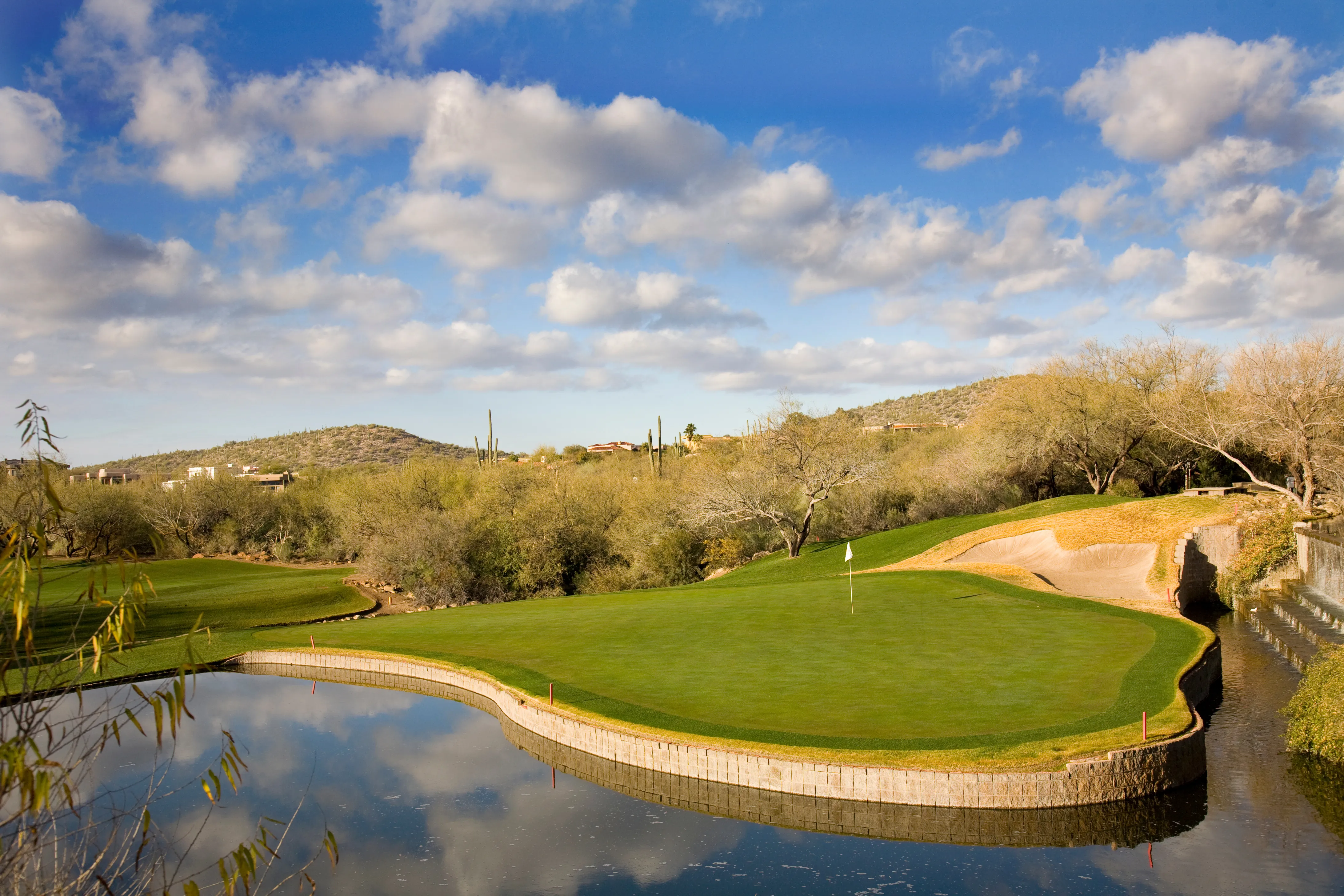 Golfers teeing off in golden desert light
