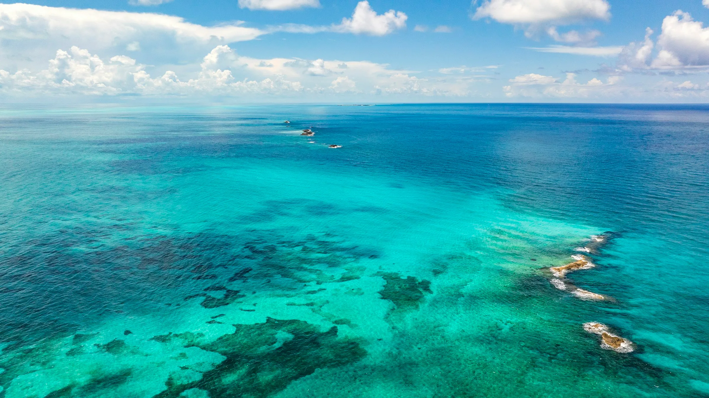 Aerial view of a Caribbean reef in turquoise water