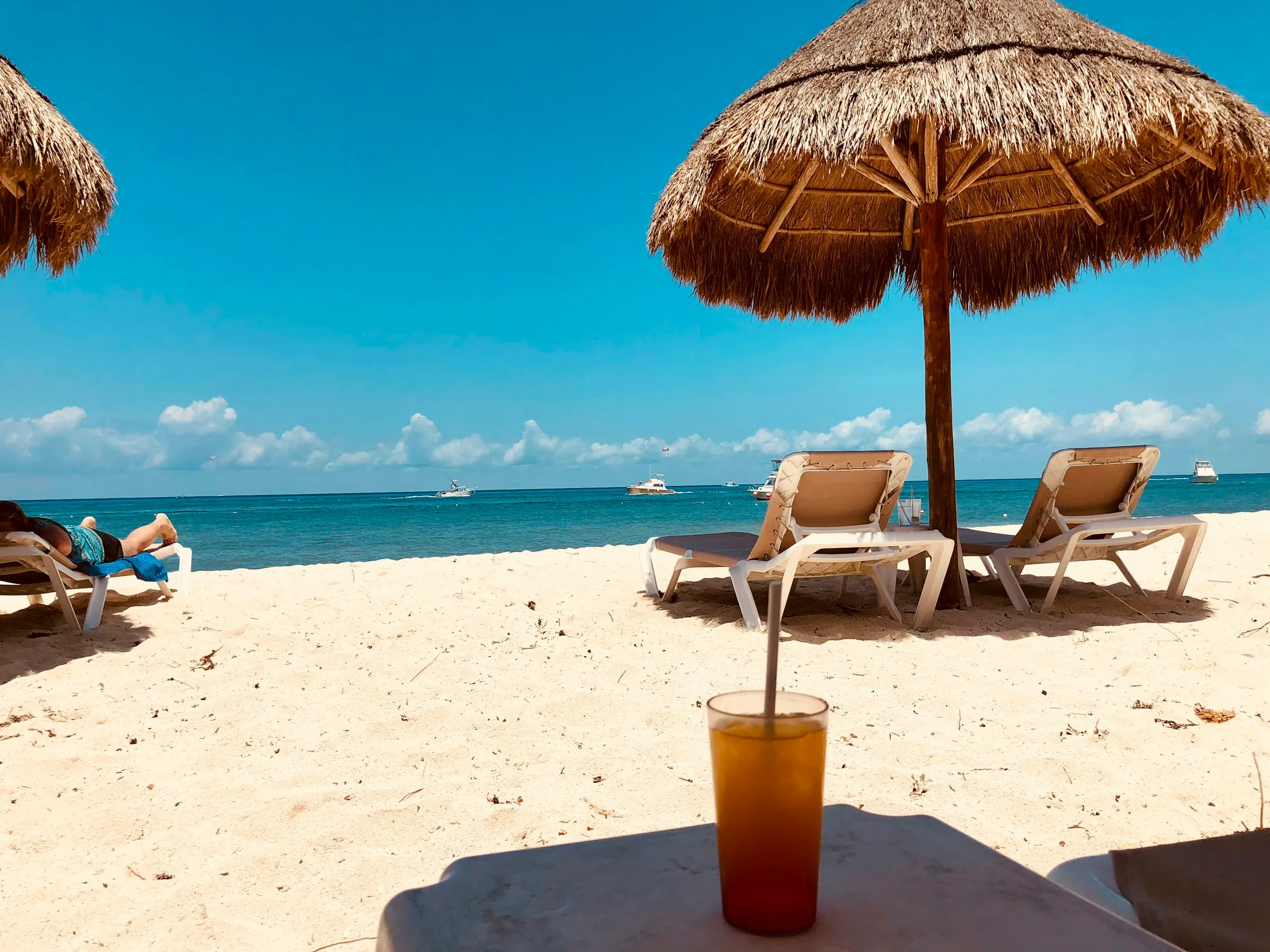 Beach chairs under an umbrella on a Cozumel beach