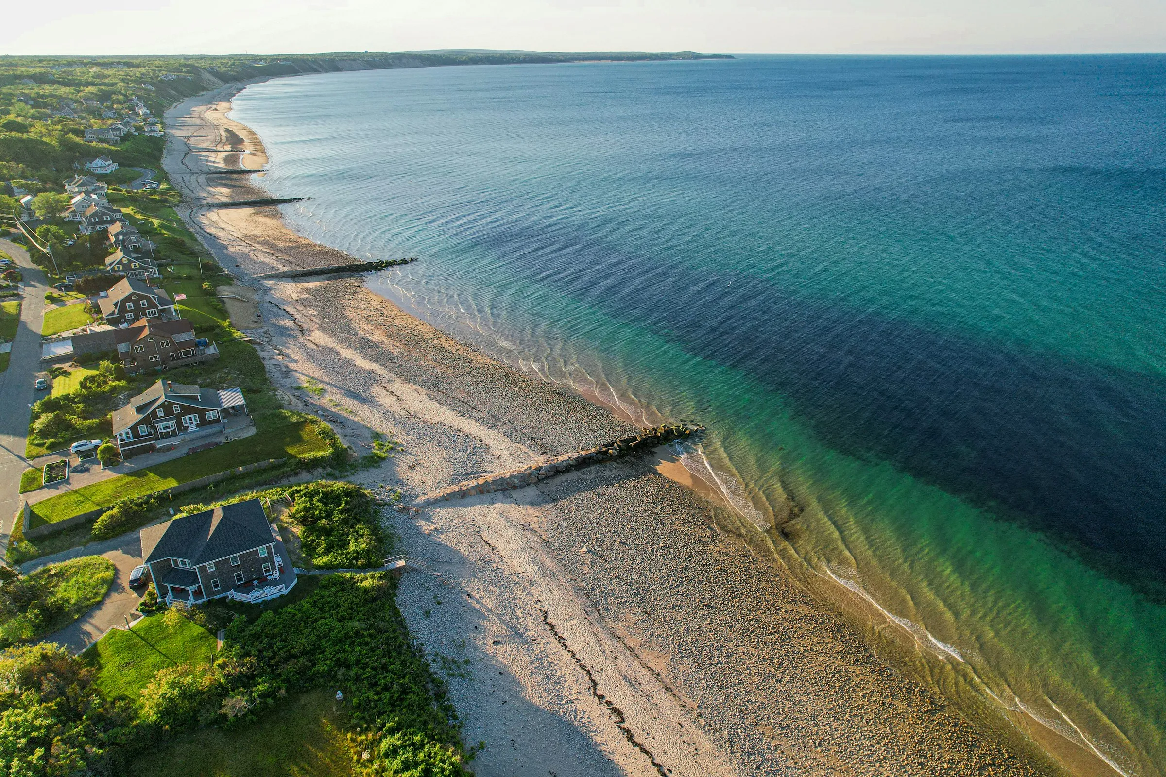 Aerial view of Cape Cod beach houses along a long sandy shore